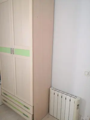 a corner of a room with a cabinet and a radiator at Espectacular apartment vistas al mar y tranquilidad 10 min desde Valencia in Puebla de Farnals