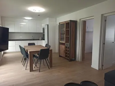 a kitchen and dining room with a table and chairs at Casa cerca de la playa con patio y garaje privado in Puerto de Sagunto
