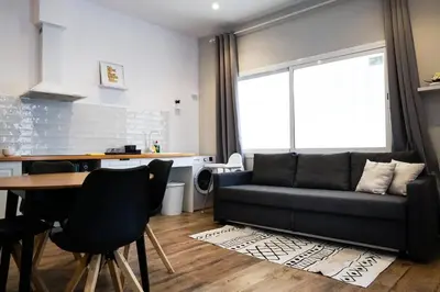 a living room with a couch and a table at Playa Apartment in Valencia