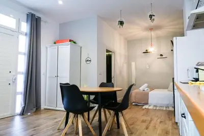a kitchen and dining room with a table and chairs at Playa Apartment in Valencia