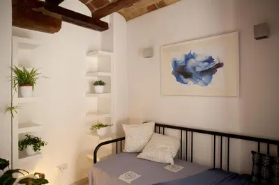 a bedroom with a bed and a picture on the wall at Authentic Charming Apartment/Wifi/Air Conditioning in Valencia