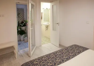 a bedroom with a door leading to a bathroom at Authentic Charming Apartment/Wifi/Air Conditioning in Valencia