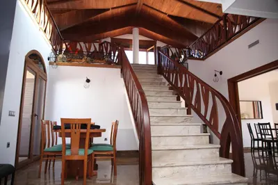 a staircase in a house with a table and chairs at Casa Genes Chera in Chera