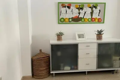 a white desk with a picture of fruit on the wall at Precioso apartamento con piscina en Moncofar in Moncófar