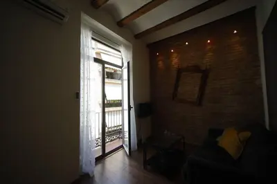 a living room with a couch and a large window at Precioso apartamento en el centro histórico in Valencia