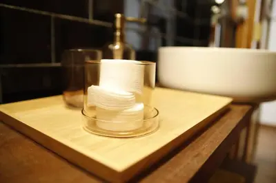 a glass container filled with toilet paper on a wooden table at Precioso apartamento en el centro histórico in Valencia