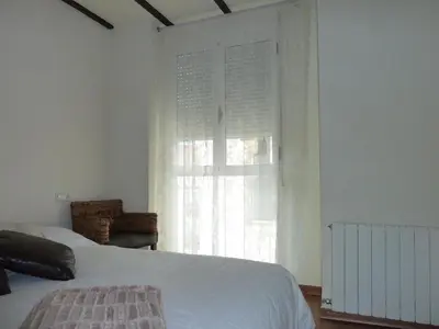 a bedroom with a white bed and a window at Apartamento con encanto CORONA in Valencia