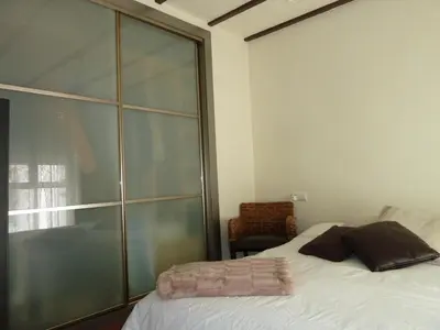 a bedroom with a bed and a glass wall at Apartamento con encanto CORONA in Valencia