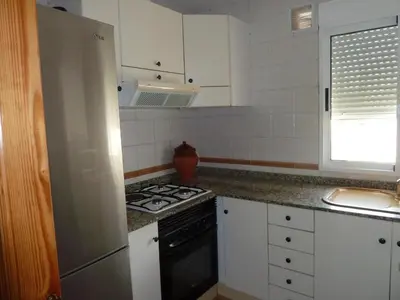 a kitchen with white cabinets and a stove top oven at Apartamento con encanto CORONA in Valencia