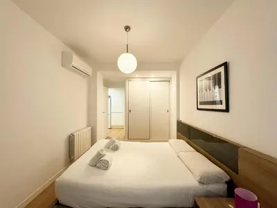 a bedroom with a large white bed in it at Luxury, design, relax, in historical street lift in Valencia