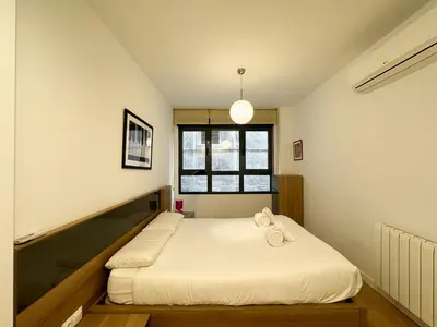 a bedroom with a bed and a window at Luxury, design, relax, in historical street lift in Valencia