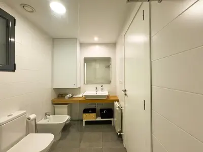 a bathroom with a sink and a toilet and a mirror at Luxury, design, relax, in historical street lift in Valencia