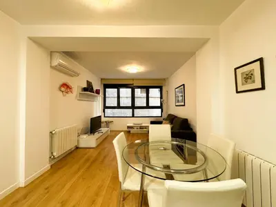 a dining room and living room with a glass table and chairs at Luxury, design, relax, in historical street lift in Valencia