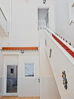 a staircase in a white house with a stair case at CASA EN LA PLAYA VALENCIA EL PERELLO in Mareny Barraquetas