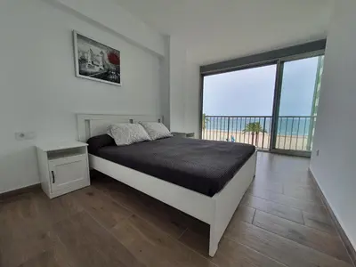 a bedroom with a bed and a large window at SingularStays Cullera IV in Cullera
