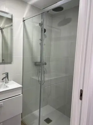 a glass shower in a bathroom with a sink at SingularStays Cullera IV in Cullera