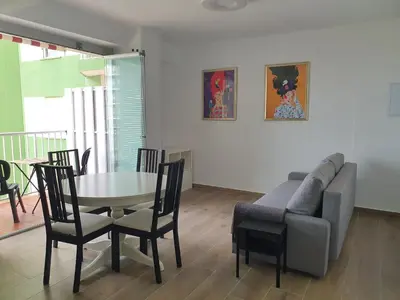 a living room with a table and a couch at SingularStays Cullera IV in Cullera