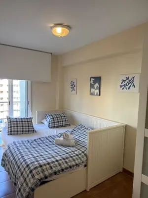 a bedroom with two beds and a window at MAGNO CULLERA- Playa in Cullera