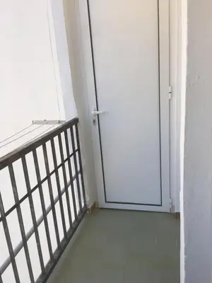 a white door in a room with a balcony at MAGNO CULLERA- Playa in Cullera