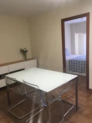 a white table and chairs in a room with a mirror at MAGNO CULLERA- Playa in Cullera