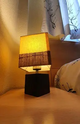 a lamp sitting on top of a bed at Piso familiar con amplia terraza 300m de la playa in Cullera