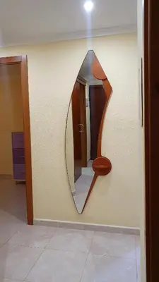 a mirror on the wall of a bathroom with a toilet at Piso familiar con amplia terraza 300m de la playa in Cullera
