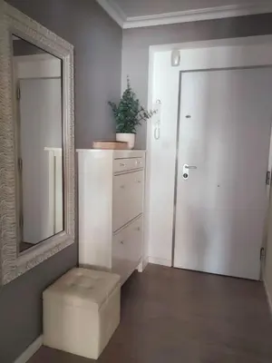 a bathroom with a mirror and a stool next to a door at Vacansis Pintor Sorolla 2 in Cullera