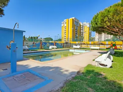 a swimming pool in the middle of a city at Global Vacacional, Apartamento con piscina en Residencial Brezo in Canet de Berenguer