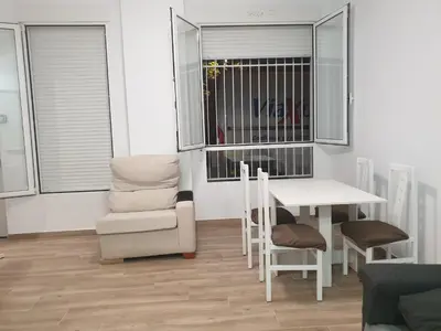 a living room with a table and a chair and a table and a chair at Premier Apartments in Valencia
