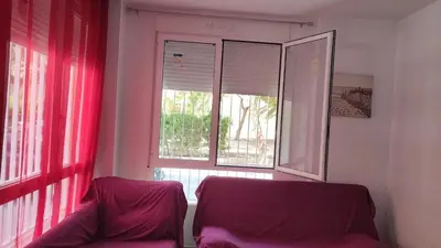 a living room with a couch and a window at Premier Apartments in Valencia