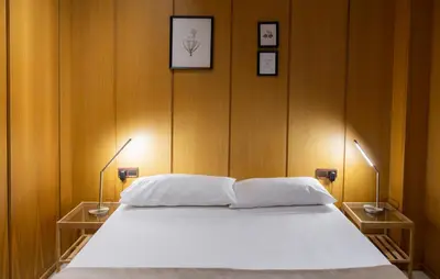 a bedroom with a white bed with two lamps at Mercat Silence in Valencia
