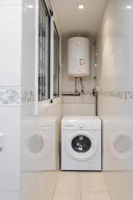 a white laundry room with a washer and dryer at Mercat Silence in Valencia