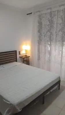a bed in a bedroom with a window with a curtain at CA PEPICA in Anna