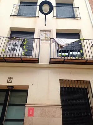 a building with two balconies and a window with a sheet at CA PEPICA in Anna