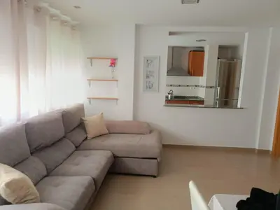 a living room with a couch and a mirror at Apartamento Casa Camacho in Burriana