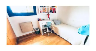 a small bedroom with a desk and a bed at Lovely penthouse condo with pool in Valencia