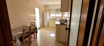 a kitchen with a refrigerator and a table and chairs at CA LAU in Burriana