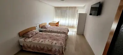 a room with two beds and a television in it at CA LAU in Burriana