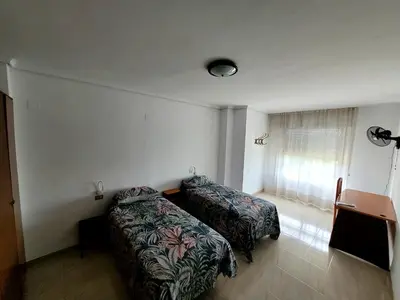 a hotel room with two beds and a window at CA LAU in Burriana