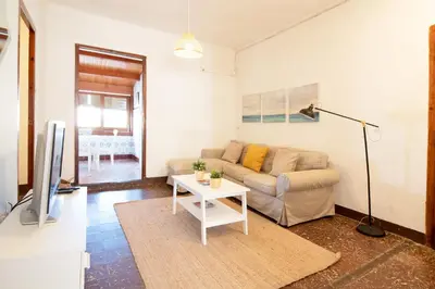a living room with a couch and a table at Global Vacacional, Apartamento céntrico en Canet d'en Berenguer in Canet de Berenguer
