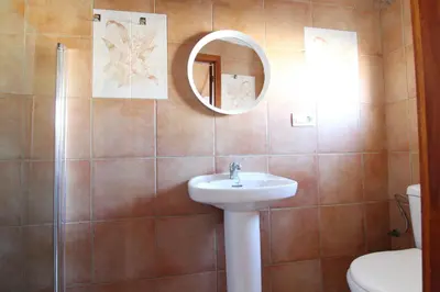 a bathroom with a sink and a mirror and a toilet at Global Vacacional, Apartamento céntrico en Canet d'en Berenguer in Canet de Berenguer