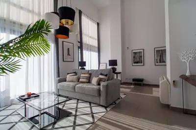 a living room with a couch and a glass table at MD Loft Valterna in Paterna