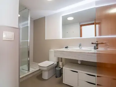 a bathroom with a toilet and a sink and a shower at MD Loft Valterna in Paterna
