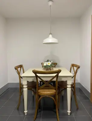 a dining room table with chairs and a pendant light at Majestic Flats in Valencia