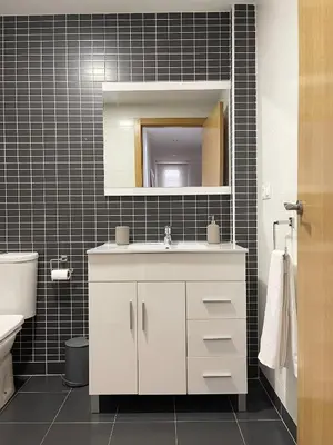 a bathroom with a white sink and a mirror at Majestic Flats in Valencia