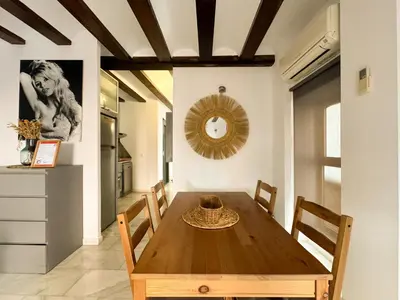 a dining room with a wooden table and chairs at Duplex en el Carmen 1 in Valencia