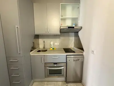 a small kitchen with a sink and a refrigerator at Duplex en el Carmen 1 in Valencia