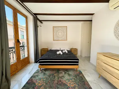 a bedroom with a bed and a large window at Duplex en el Carmen 2 in Valencia