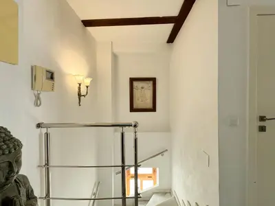 a staircase in a building with a statue at Duplex en el Carmen 2 in Valencia