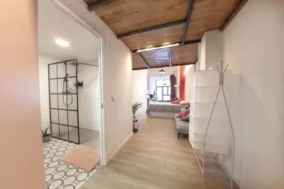 a hallway with a glass door leading to a living room at NB - Cozy loft steps from City of Arts & Sciences in Valencia